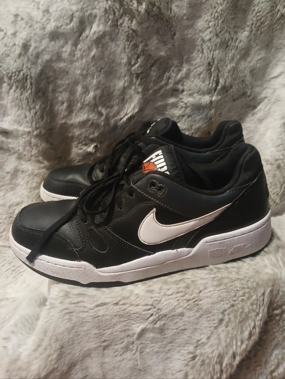 Nike Black Sneakers with White Soles and Orange Tongue Accent